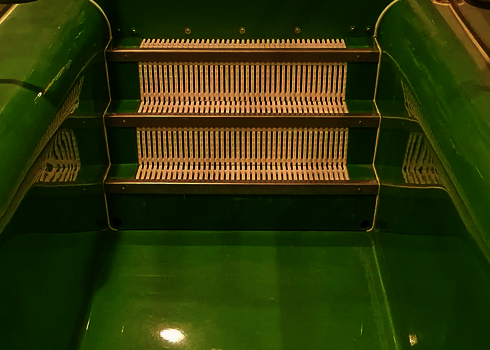 Green exercise area with three white plastic grids as steps in the water basin.