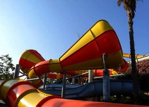 Gelb-roter Crazy Cone von schräg unten mit mehreren Trichtern und Röhrenrutschen.