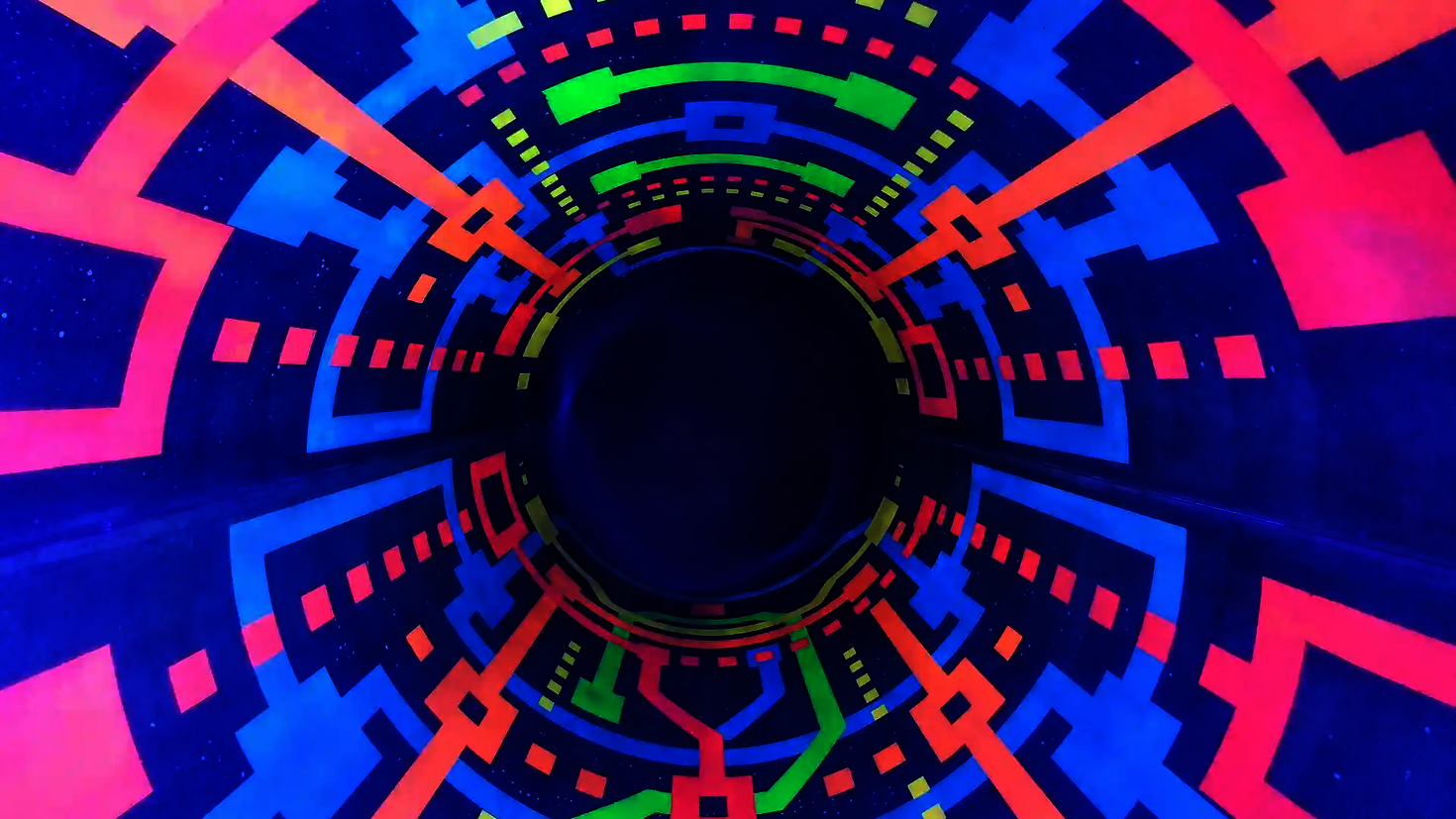 Leuchtende geometrische Muster in Neonfarben unter Schwarzlicht in Röhrenrutsche.