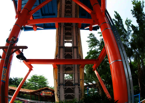 Three yellow slide rafts wait in the covered entrance area to be transported by raft conveyor.