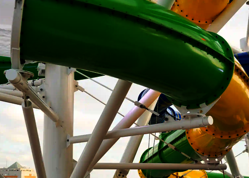 Nahaufnahme eines grünen Elements der Wasserrutsche RR900 mit weißen Stahlträgern.
