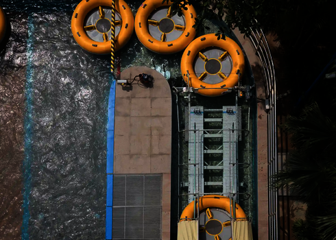View from above of the outlet basin with yellow slide rafts and the entrance to the raft conveyor.