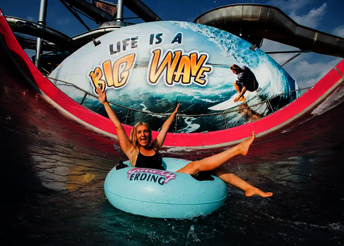 Eine Frau jubelt auf einem blauen Reifen am Ende der Sidewinder.