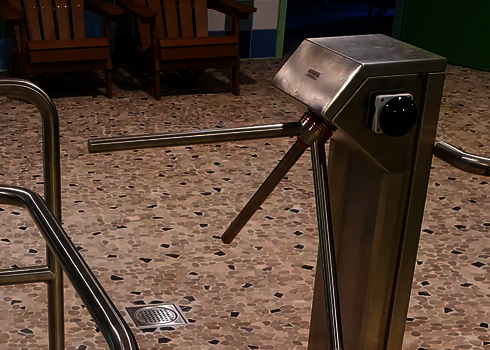 Stainless steel turnstile in the entrance area of the water slide facility.