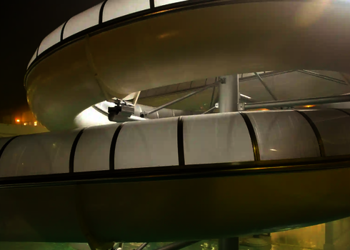 Weiße WR1040-Rutsche mit Beleuchtung in einem Innenbereich bei Nacht.