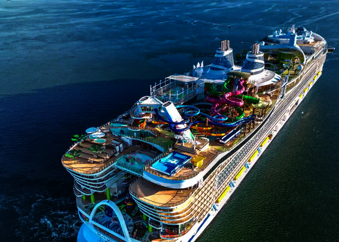 Vogelperspektive auf das Decks eines Kreuzfahrschiffes auf offenem Ozean mit Freizeitangeboten.