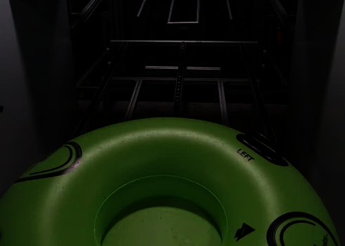 Interior view of the lift with green slide raft, embedded in a guide system.