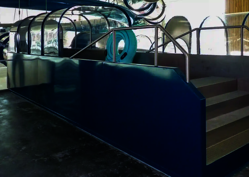 Slide landing platform with covered start area and blue entry for raft slides.