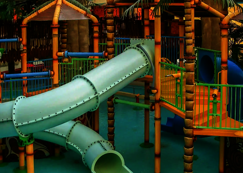 Kinderbereich im Dschungel-Stil in einem Hallenbad mit Klettergerüst und RR900 - Kids Wasserrutsche.