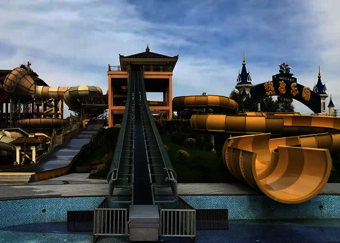 Central entrance with integrated green raft conveyor between several tube slides.