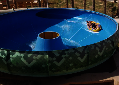 Blick von der Seite in eine blaue Raft Bowl mit rutschenden Personen.