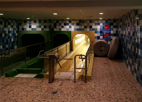 Starting area for two slides with railings and inflated tyres next to them.