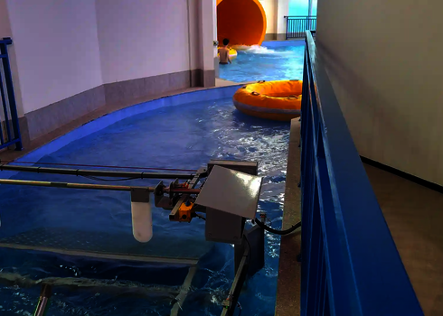 A yellow rubber dinghy floats in the water as the raft conveyor picks it up for further transport.